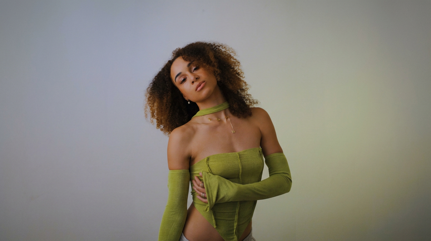 Noreena McCleave in a green top against a soft neutral studio backdrop